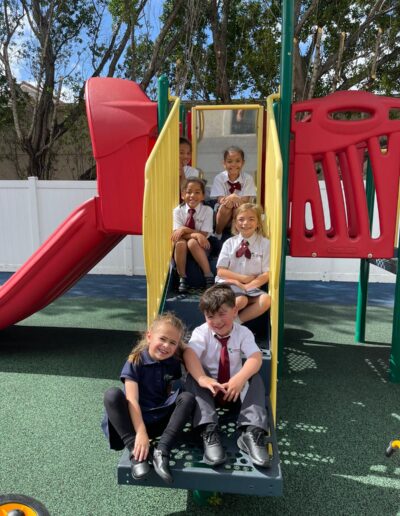 Kids sitting in the STARS Global Prep playground during recess